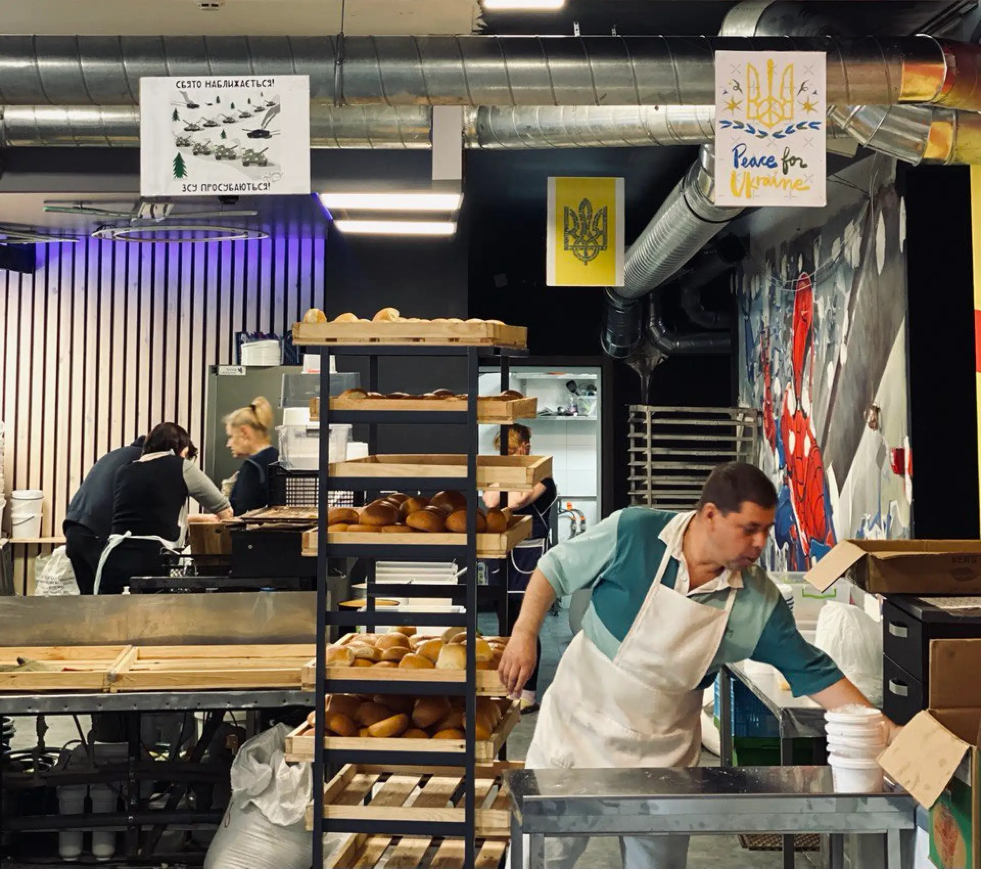Inside the kitchen — bread racks and Peace for Ukraine posters